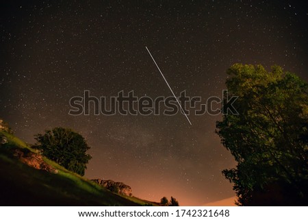 Spring Milky Way and satellite in the night sky.
