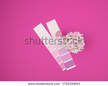 A bouquet of spring flowers in a watering can and a palette of flowers on a pink background.