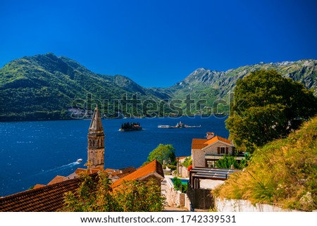The small town of Perast is one of the most famous and visited tourist places in Montenegro.T he bell tower of the Church of St. Nicholas against the background of the Bay of Kotor and the mountains.