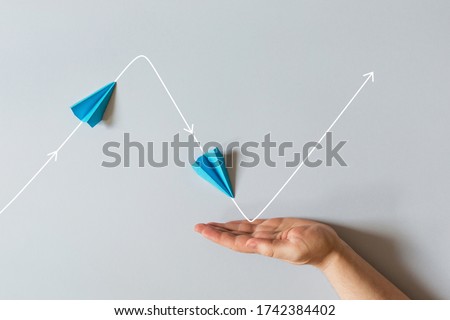 concept of small business support. graph of of economic crisis, stagnation and recovery with help of state. paper plane flies up, falls down. Royalty-Free Stock Photo #1742384402