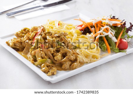 pasta with chicken tomato sauce on a white plate