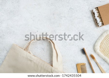 Zero waste, ecology concept. Plastic free bathroom accessories and textile shopping bag on light background. Top view, flat lay, copy space