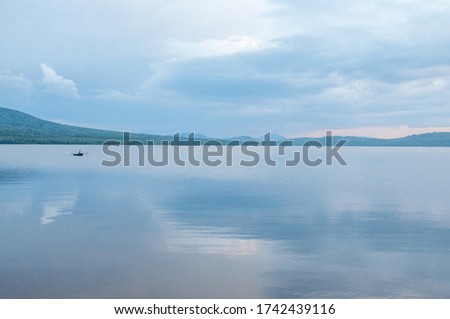 Beautiful blue lake and sky reflection, smooth surface of water Royalty-Free Stock Photo #1742439116