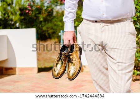 Closeup view of stylish man with funky golden shoes ready for party celebration event