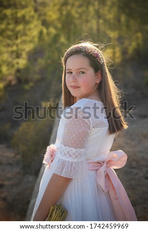 elegant girl dressed in first communion