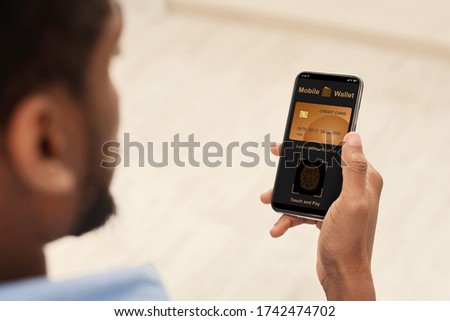 Online transaction concept. African-american man using smartphone for online shopping