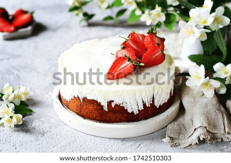 Strawberry cake with cream in a plate on a gray background