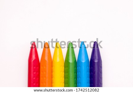 Creativity concept. Crayons of rainbow colors on a white background. Copy space