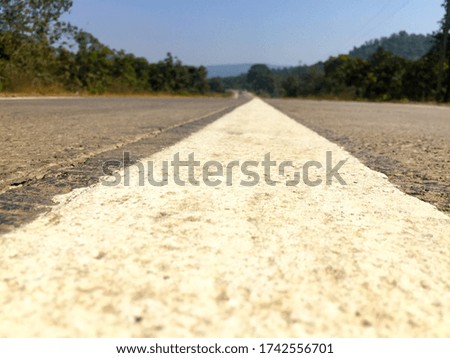 This picture is of a low shot highway marking on a sunny day.