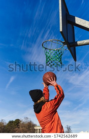 A pretty young blond woman playing basketball.                            