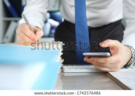 Businessman signs stack documents in table office. Man created workplace at home during quarantine. Simplification procedure for signing documents during self-isolation. Ability to quickly sign
