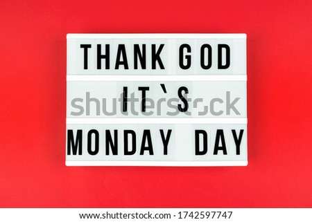 Text Thank God it's Monday day on a lightbox on a red background. Support of business