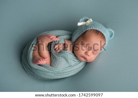 sleeping newborn baby in a wrap Royalty-Free Stock Photo #1742599097