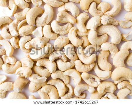 White raw cashew nuts in a white background stock image.