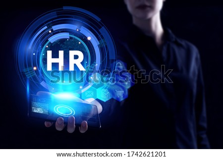 Business, Technology, Internet and network concept. Young businessman working on a virtual screen of the future and sees the inscription: HR