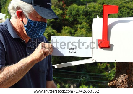 Man mailing in a ballot during the covid-19 pandemic Royalty-Free Stock Photo #1742663552