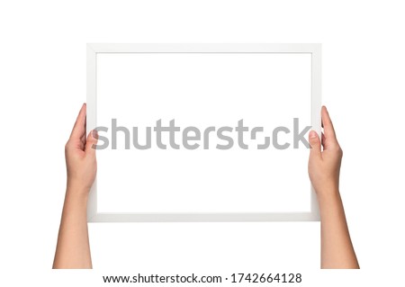White frame. Woman hanging a frame. Empty white frame template.