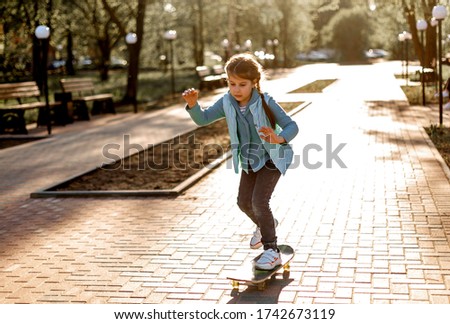 
child in the park on a skateboard