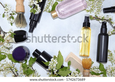 Spa ingredients, a set of cosmetic products for skin and body care for men with branches of blooming cherry. Shopping concept and modern man, sale, selective focus, place for text