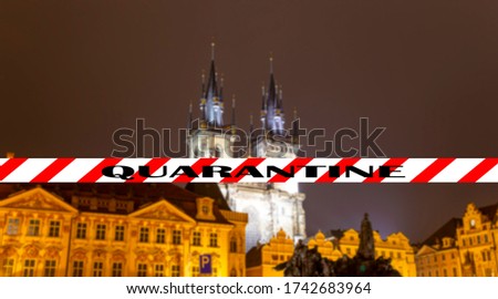 Coronavirus in Prague, Czech Republic. The gothic Church of Mother of God in front of Tyn. Quarantine sign on a blurred background. Concept of COVID pandemic and travel in Europe.