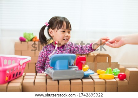 toddler girl pretend play sweet shop keeper at home  Royalty-Free Stock Photo #1742695922