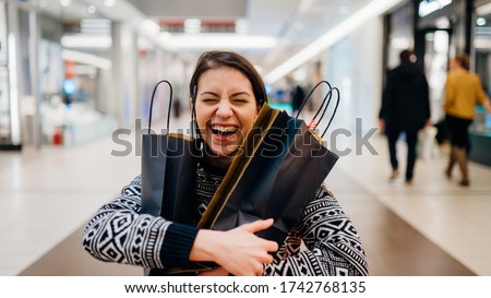 Excited shoppingholic woman in shopping mall.Buying in designer store.Wardrobe sale shopping.Hoby buyer.Weakness for clothes.Clothing shopping after reopening stores.New apparel retail store opened. Royalty-Free Stock Photo #1742768135