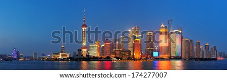 Urban skyscrapers in Shanghai at night over river