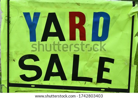 Colorful yard sale sign with large text