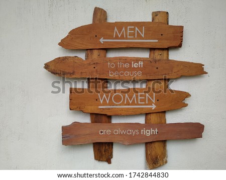 men to the left because women are always right. wood sign for public toilet