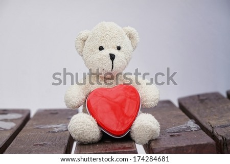 Teddy bear holds a red heart