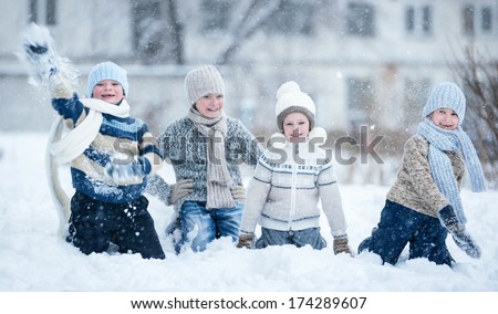Children playing in the snow on a winter day