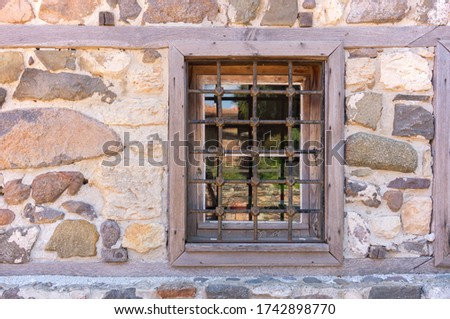 Barred window in a stone wall