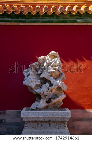 Red wall with unique stone in the forbidden city. Chinese traditional symbols. Minimal background.
