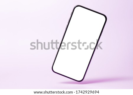 Smartphone mock up, phone with blank screen and shadow isolated on purple background. Modern technologies social networks and applications. Symbol of lightness freshness airiness. Copy space