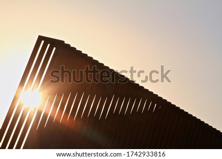 Sunlight through a modern architecture at sunset
