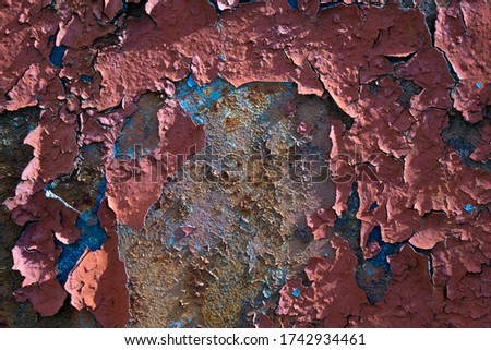 Old painted wall with peeled paint. Rusty metal wall with cracked paint. Abstract vintage background in post-apocalyptic style. 