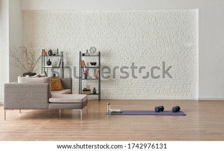 Training at home concept, grey sofa and mat style. Royalty-Free Stock Photo #1742976131