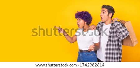 isolated young couple with shopping bags