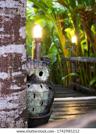 Earthenware sculpture of An owl in the garden behind the vacation home