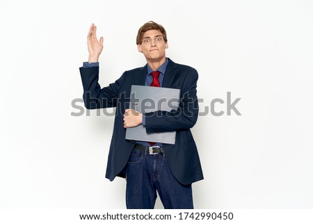 A man with a raised hand tie a jacket documents