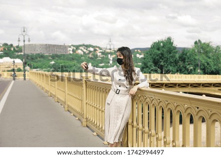 Asian girl is taking selfie on the bridge