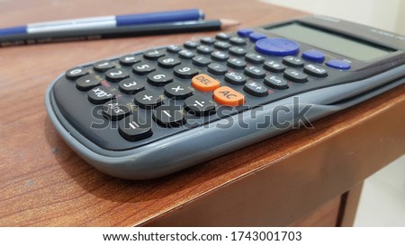 Closeup picture of a calculator on table.