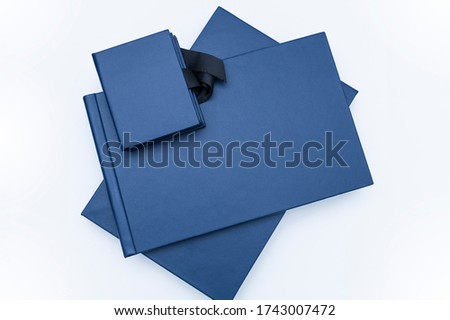 Elegant leather wedding photobooks on Navy blue or photo albums on the white background.