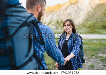 happy young couple hiking in mountain