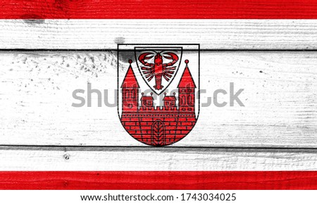 Cottbus flag painted on old wood plank background. Brushed natural light knotted wooden board texture. Wooden texture background flag of Cottbus