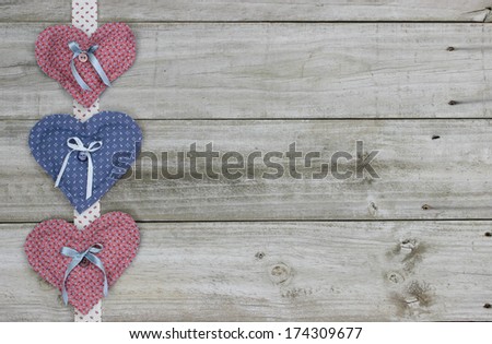 Pink and blue calico hearts border wood background