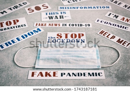 "Freedom. Help me. Misinformation. This is war. Stop the lockdown.I am tired. Fake news in Covid-19. Fake pandemic." Lettering on the background of a medical mask. Protest banner.