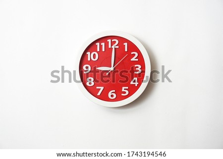 The red clock shows 9 o'clock and is isolated with a white background.