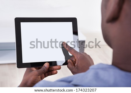 Close-up Of African Person Holding Blank Digital Tablet