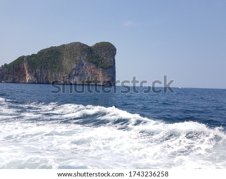 A beautiful rock mountain beside blue ocean